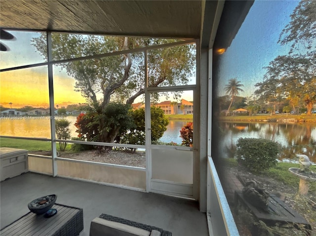 unfurnished sunroom with a water view