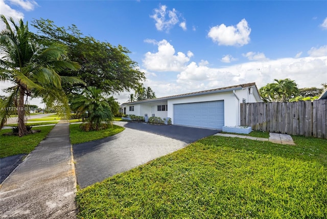 ranch-style home with a garage and a front yard