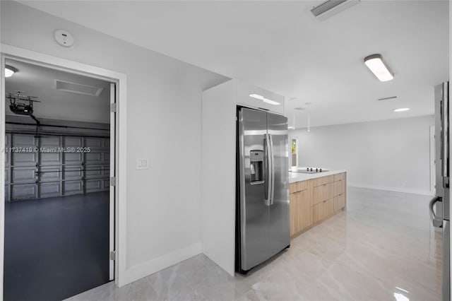 interior space featuring light brown cabinets, black electric cooktop, and stainless steel fridge with ice dispenser