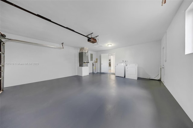 garage featuring a garage door opener and washing machine and dryer