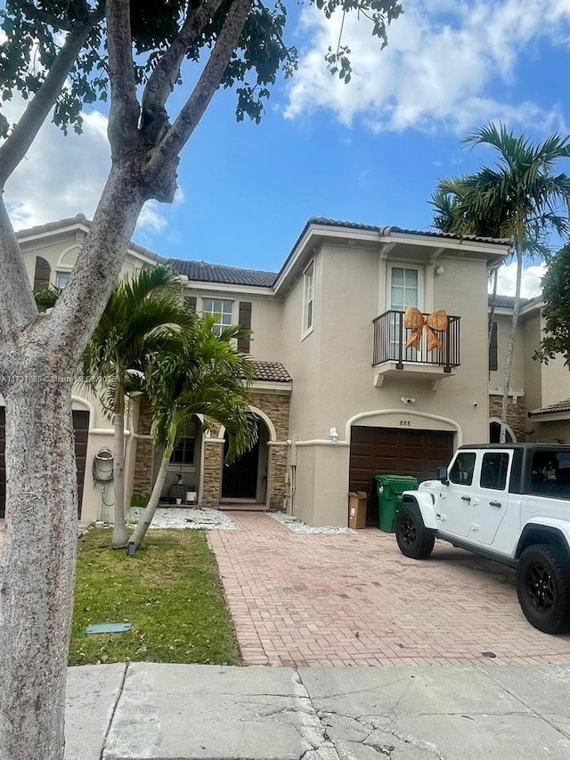 view of front of home with a balcony and a garage