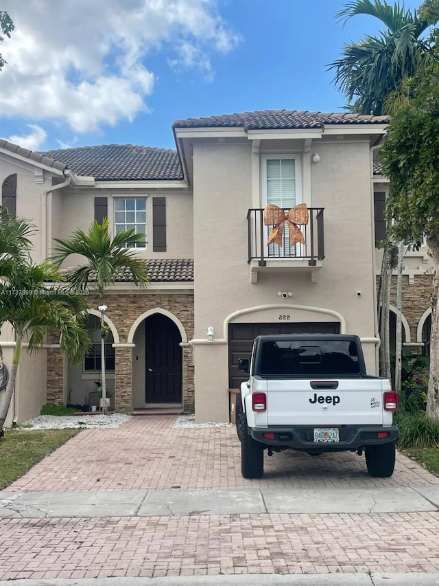 view of front facade featuring a balcony and a garage