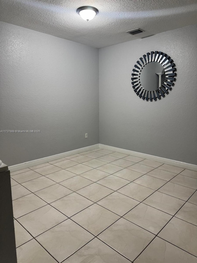 spare room featuring a textured ceiling