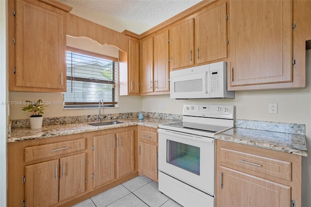 kitchen featuring sink, light stone counters, a textured ceiling, light tile patterned floors, and white appliances