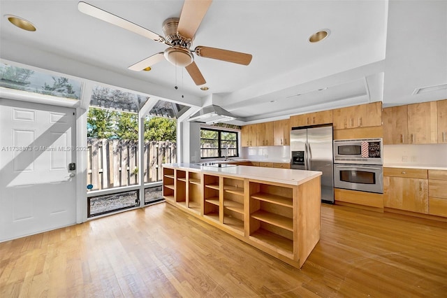 kitchen with stainless steel appliances, ceiling fan, and light wood-type flooring