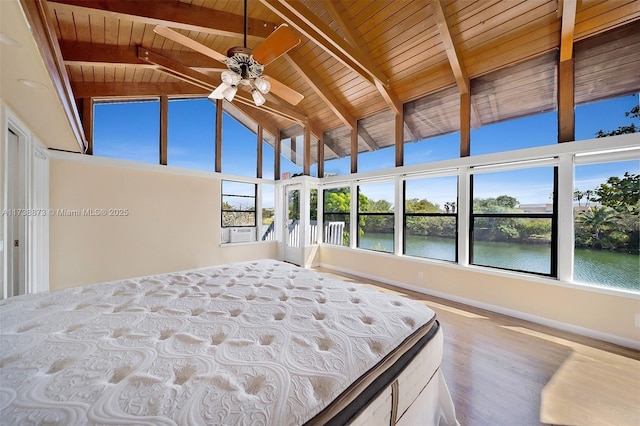 unfurnished bedroom featuring hardwood / wood-style floors, high vaulted ceiling, beamed ceiling, wood ceiling, and a water view