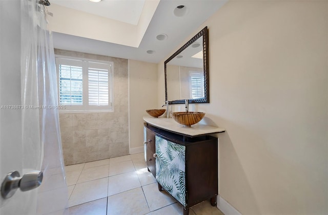 bathroom with vanity, a skylight, and tile patterned flooring