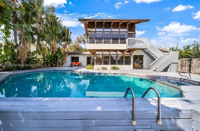 view of swimming pool with a sunroom