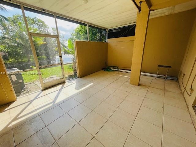 unfurnished sunroom with a water view