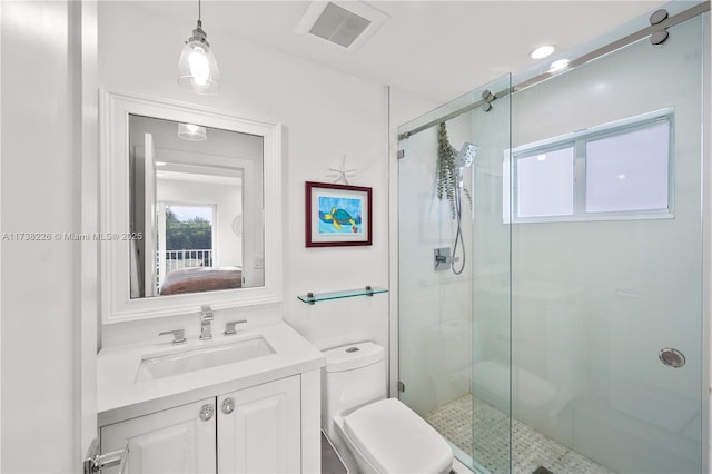 bathroom featuring vanity, toilet, and an enclosed shower