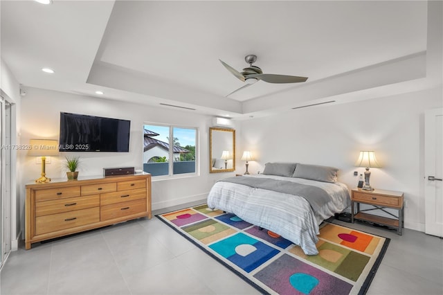 bedroom with light tile patterned floors, a raised ceiling, and ceiling fan