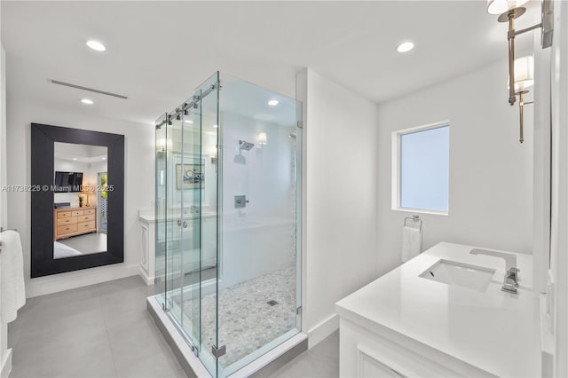 bathroom with vanity, an enclosed shower, and tile patterned flooring