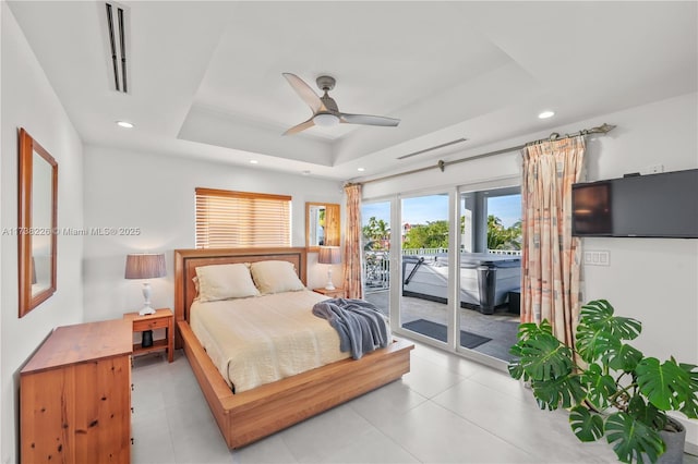 bedroom with ceiling fan, a raised ceiling, and access to outside