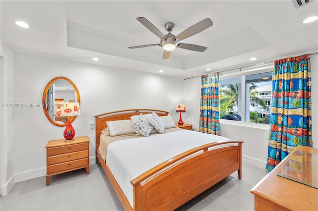 bedroom featuring ceiling fan and a raised ceiling