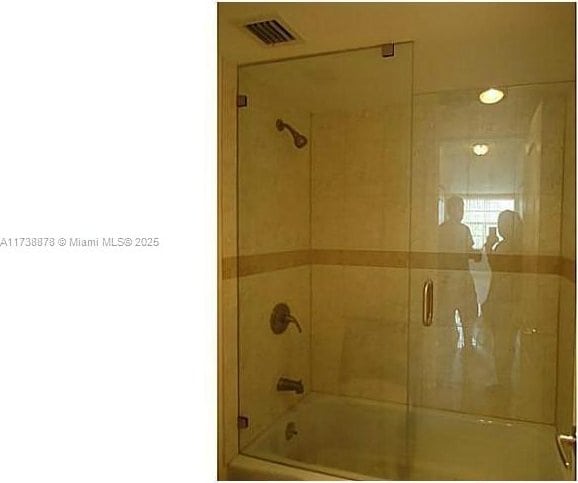 bathroom featuring shower / bath combination with glass door