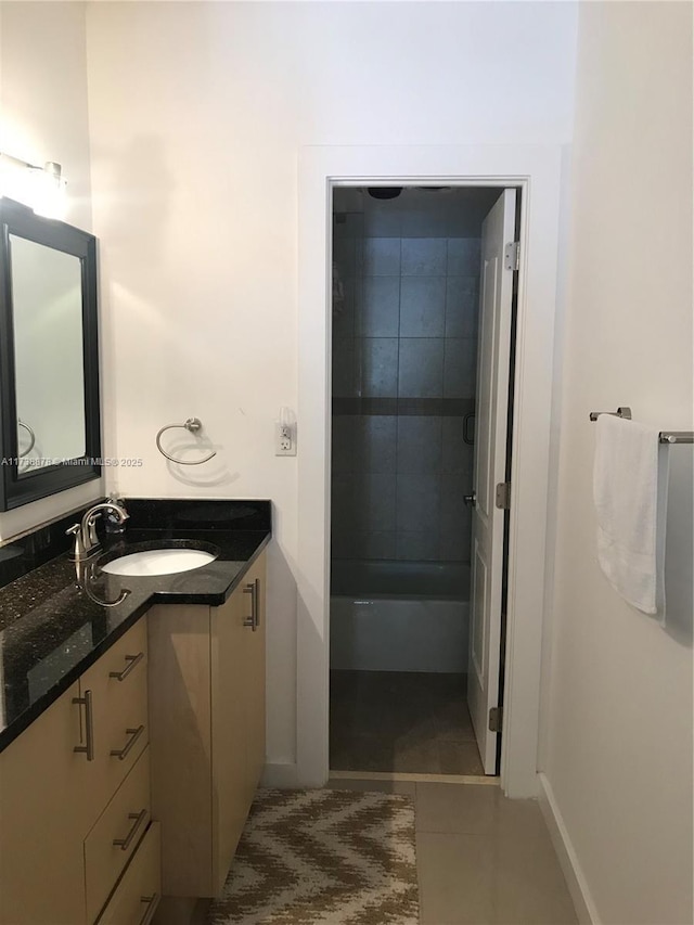 bathroom featuring vanity, tile patterned floors, and tiled shower / bath