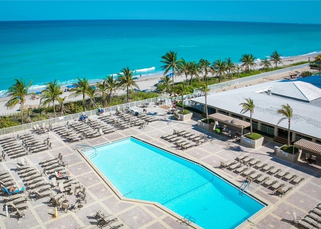 view of swimming pool featuring a patio and a water view