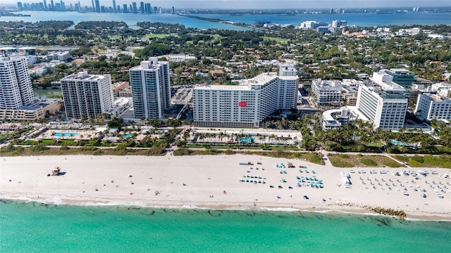 drone / aerial view featuring a water view and a beach view