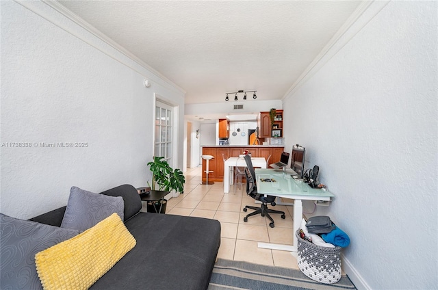 tiled office with rail lighting, crown molding, and a textured ceiling