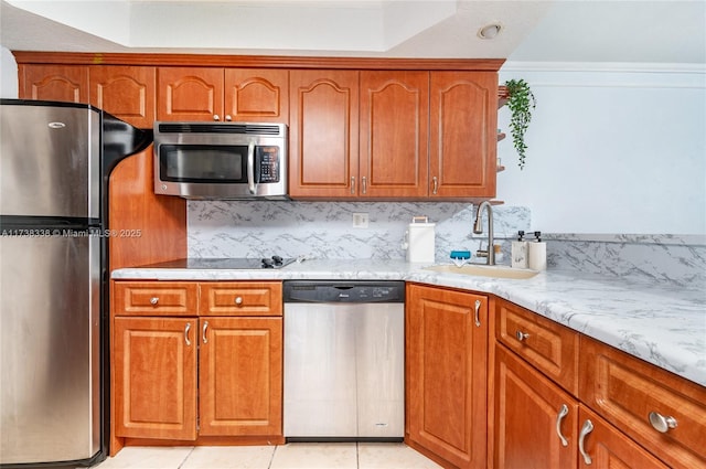 kitchen with sink, crown molding, light tile patterned floors, stainless steel appliances, and tasteful backsplash