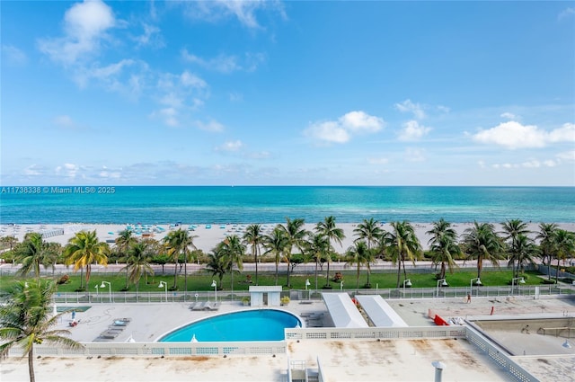 exterior space featuring a water view and a beach view