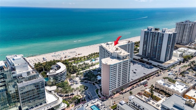 drone / aerial view featuring a view of the beach and a water view