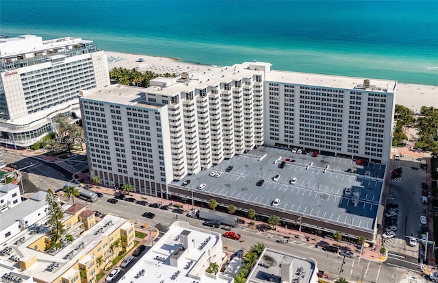 birds eye view of property with a view of the beach and a water view