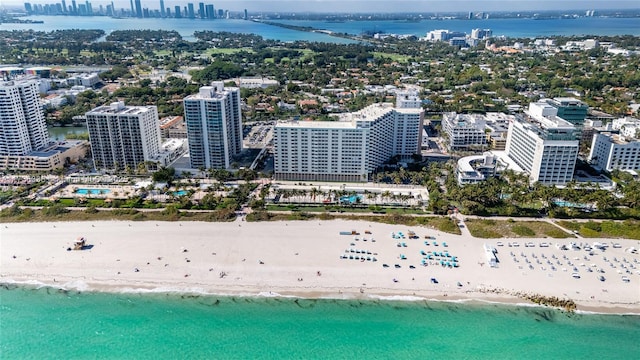 bird's eye view featuring a water view and a beach view