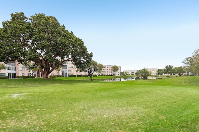 view of community featuring a lawn and a water view