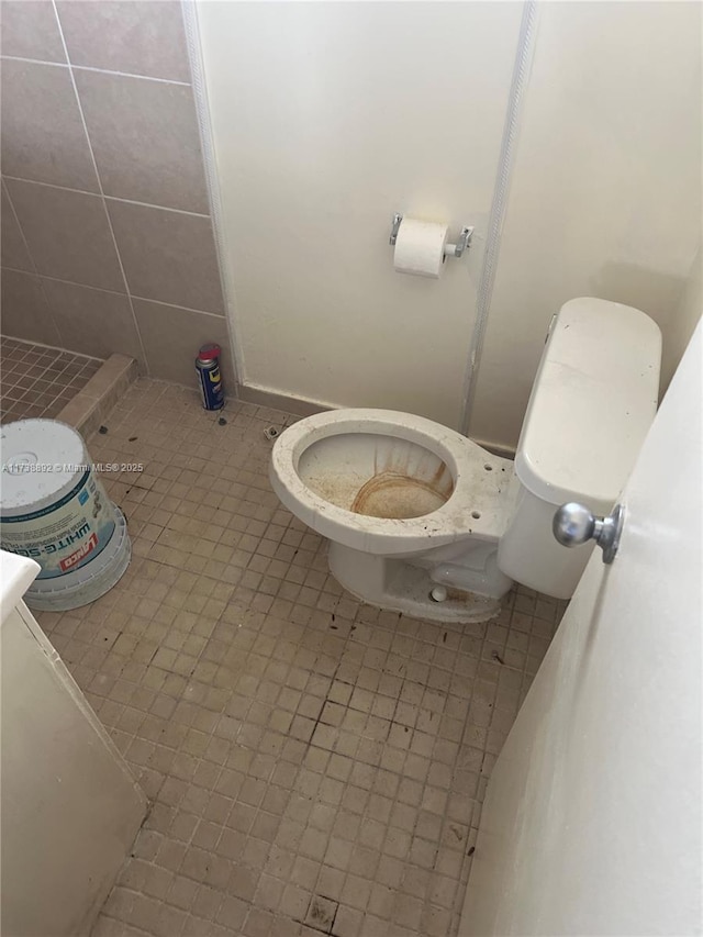 bathroom featuring toilet and tile patterned flooring