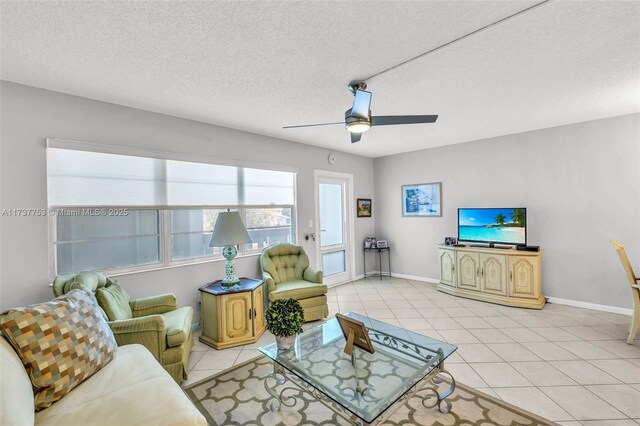 tiled living room featuring ceiling fan and a textured ceiling