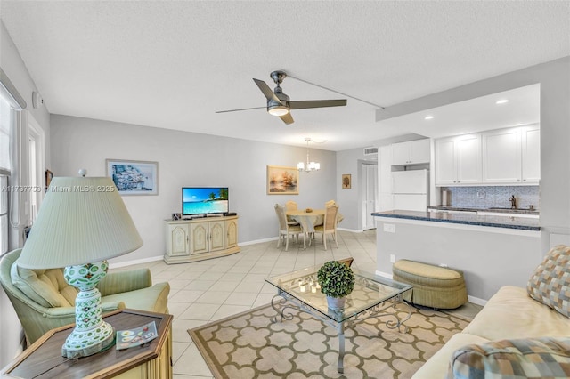3011 Islewood D 3011, Deerfield Beach, FL 33442 - living room featuring a textured ceiling, light tile patterned flooring, baseboards, recessed lighting, and ceiling fan with notable chandelier