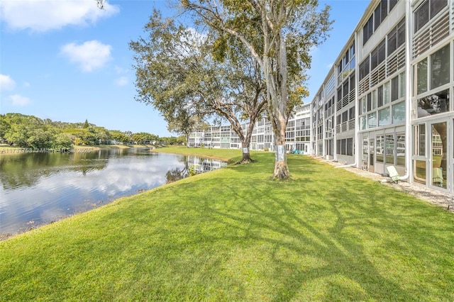 exterior space with a water view and a lawn