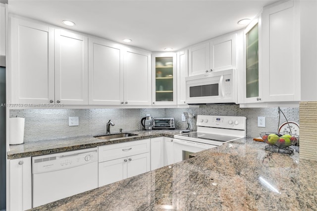 kitchen featuring white appliances, a sink, and white cabinetry