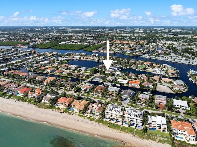 bird's eye view featuring a water view and a beach view