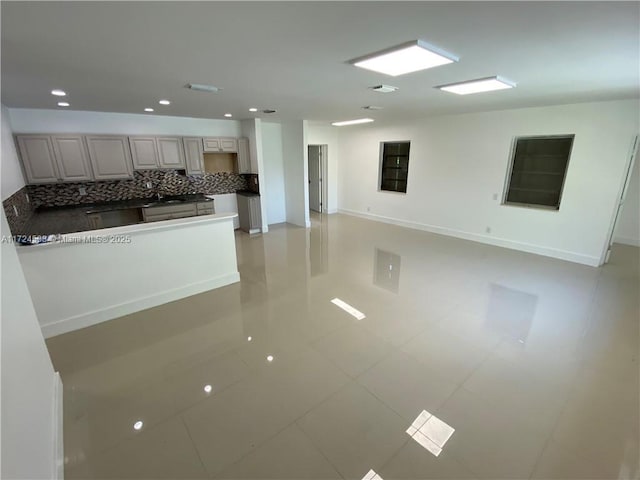 unfurnished living room featuring sink