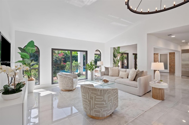 living area featuring high vaulted ceiling and an inviting chandelier