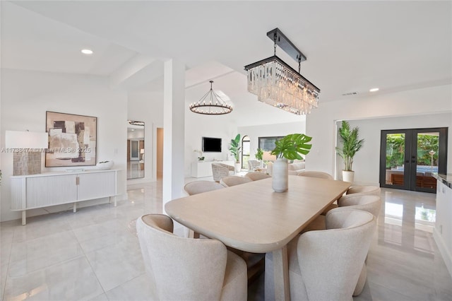 dining room featuring french doors, a notable chandelier, recessed lighting, visible vents, and a towering ceiling