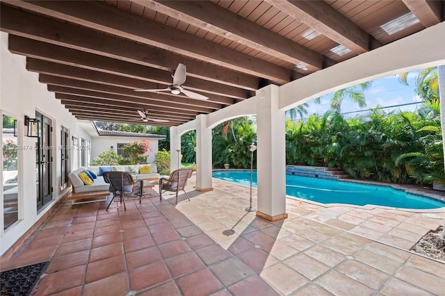 pool with french doors, outdoor lounge area, ceiling fan, and a patio