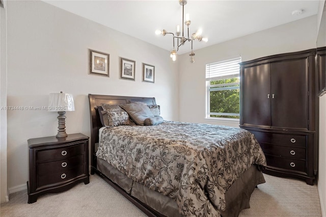 carpeted bedroom featuring a notable chandelier