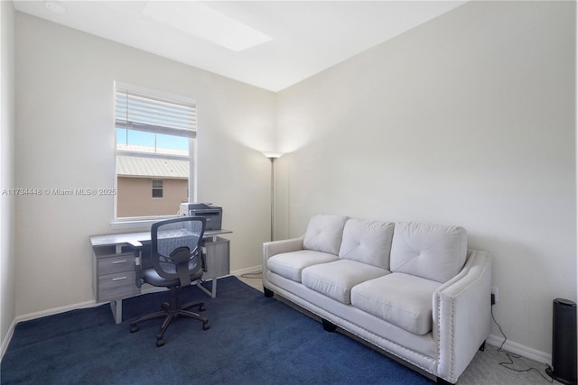 carpeted office space featuring a skylight