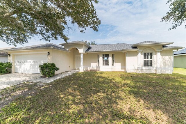 ranch-style home with a garage and a lawn