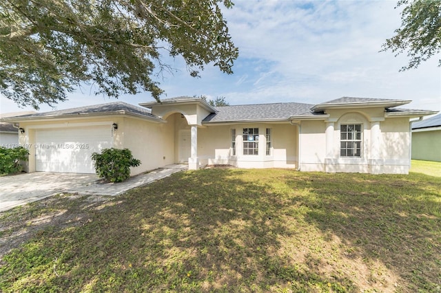 view of front of home featuring a front yard, driveway, an attached garage, and stucco siding