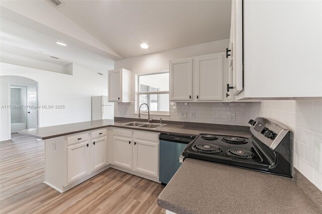 kitchen featuring stainless steel appliances, white cabinetry, sink, and kitchen peninsula