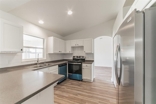 kitchen with sink, white cabinetry, stainless steel appliances, vaulted ceiling, and light wood-type flooring