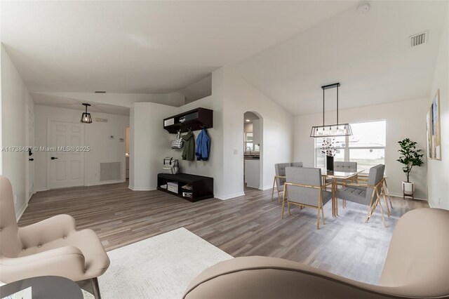 living room with wood-type flooring and vaulted ceiling