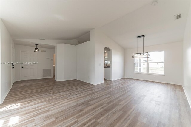 unfurnished living room with lofted ceiling and light hardwood / wood-style flooring