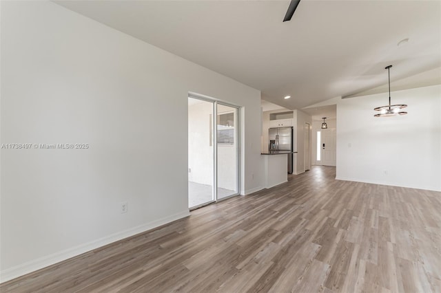 unfurnished living room with light wood-type flooring, lofted ceiling, baseboards, and recessed lighting