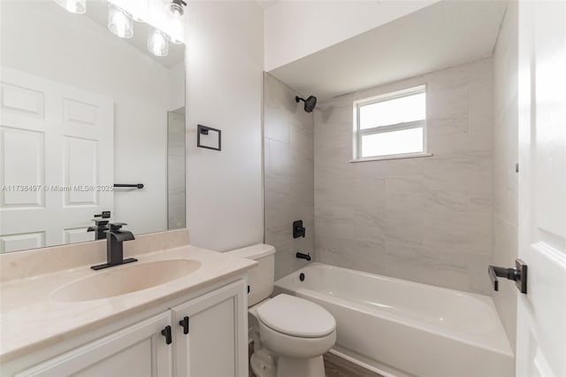 bathroom with bathtub / shower combination, vanity, and toilet