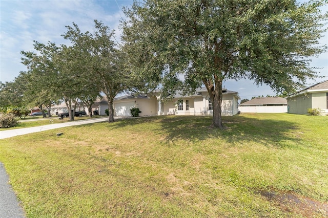 single story home with a garage, concrete driveway, and a front lawn